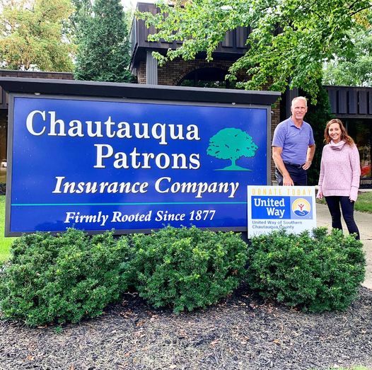 Mark Prechtl of Chautauqua Patrons Poses With Yard Sign